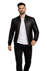 Man wearing a black leather jacket over a white shirt on a white background